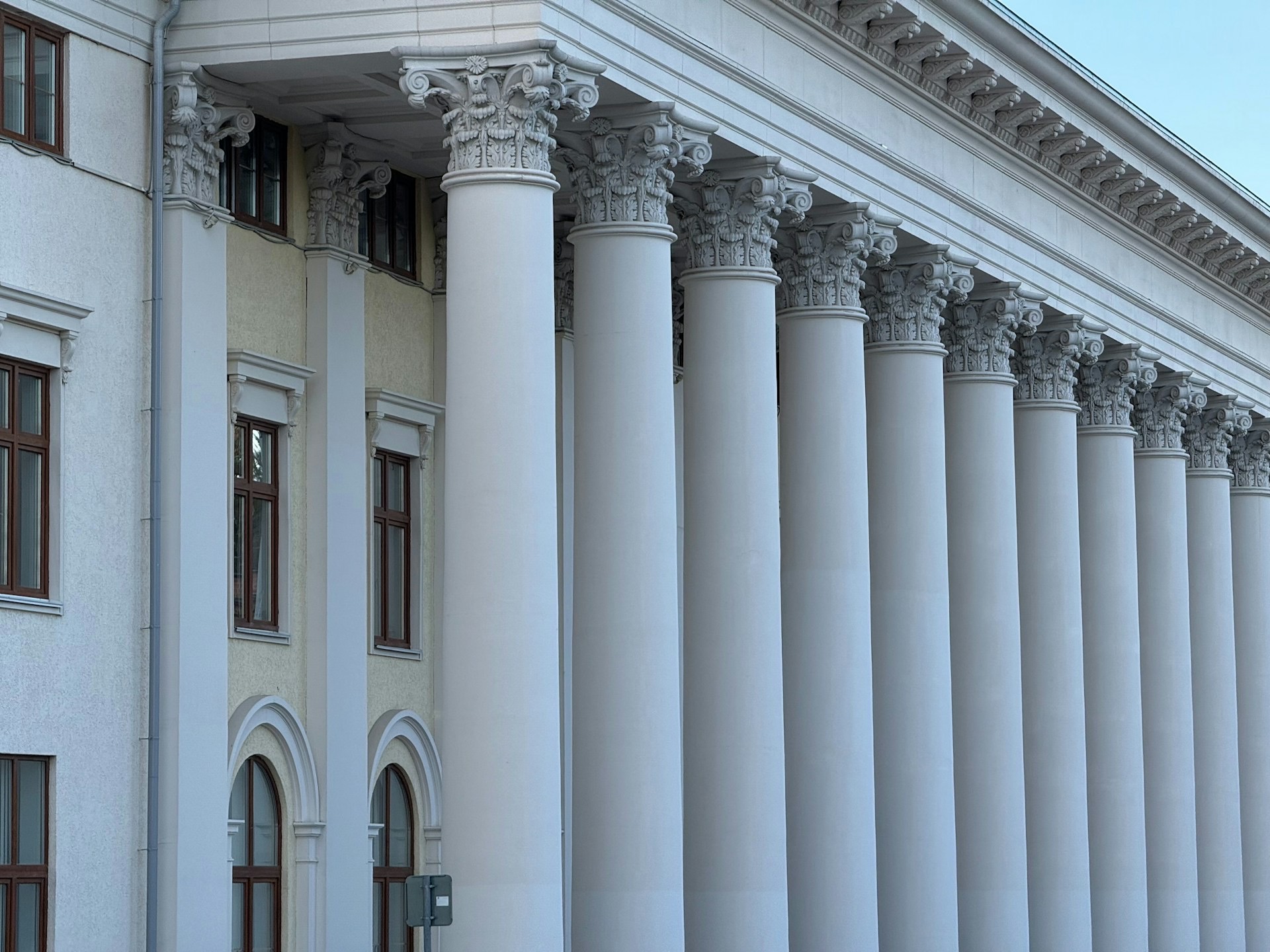 Classical white columns on the facade of a grand government building