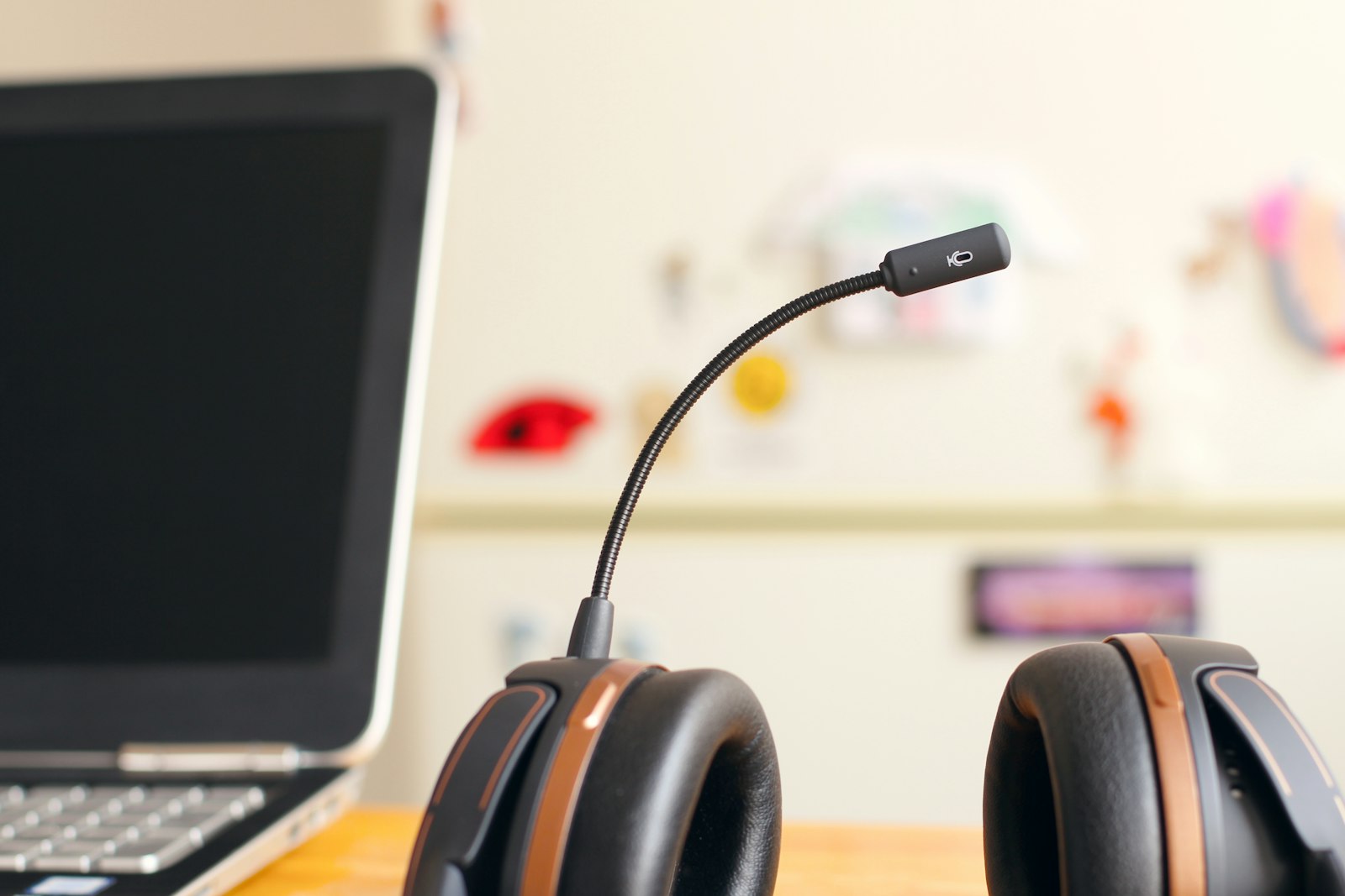 A support headset resting beside a laptop on a desk
