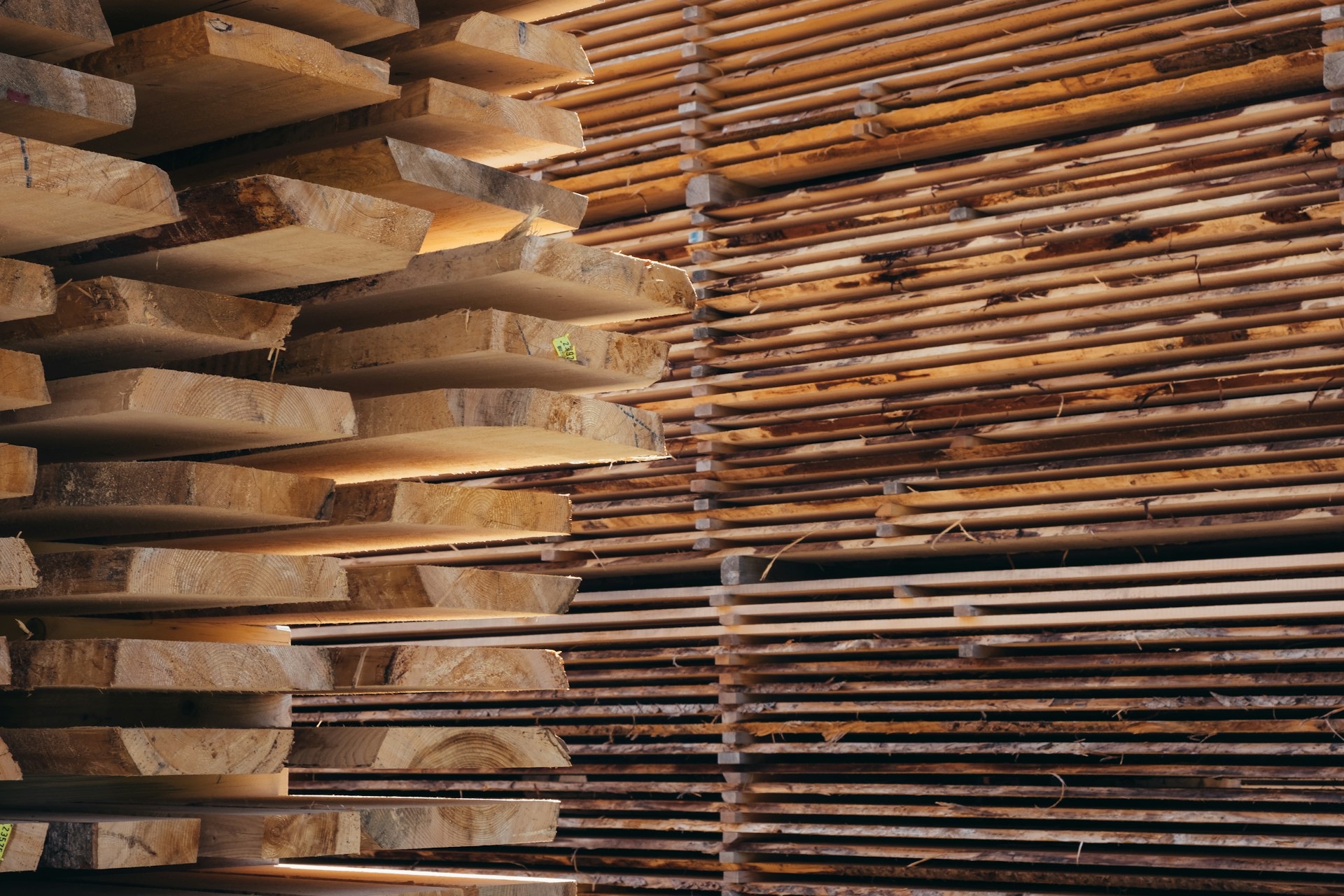A tall stack of sawn timber planks at a timber yard