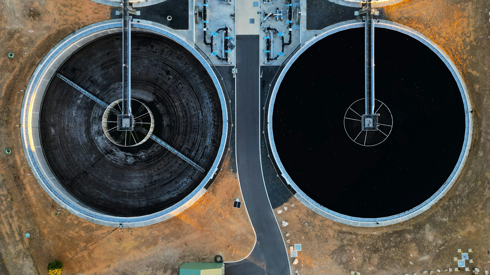 Two circular water treatment tanks side by side, seen from directly above