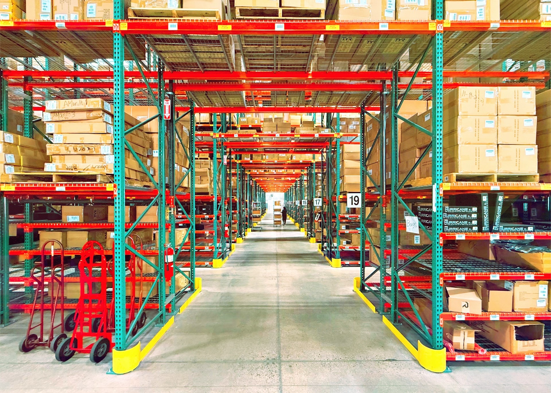 A warehouse aisle lined with shelves and boxes