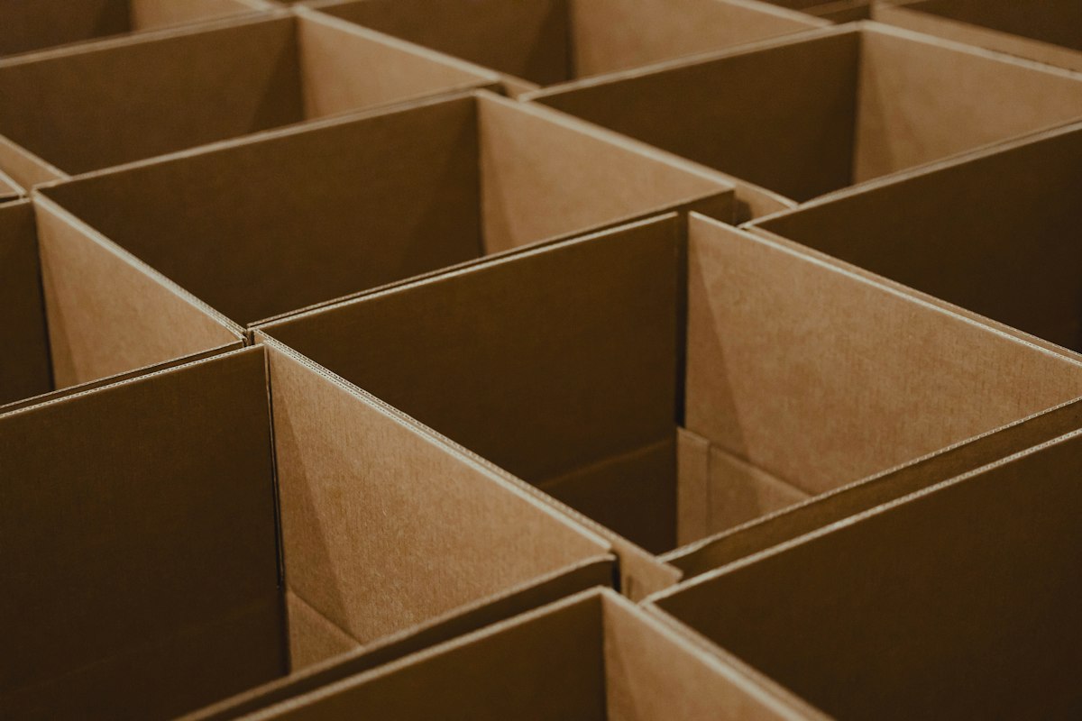 Rows of open cardboard boxes in an even grid, each with its own space