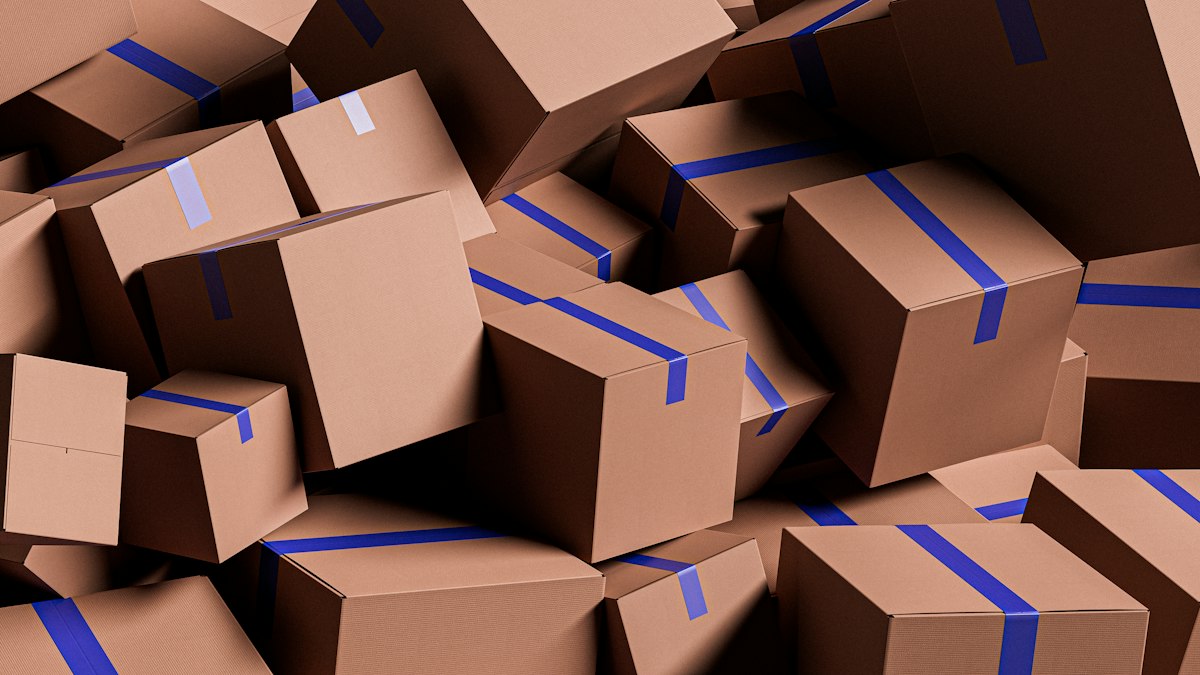 A tumbled heap of taped cardboard boxes, none of them marked