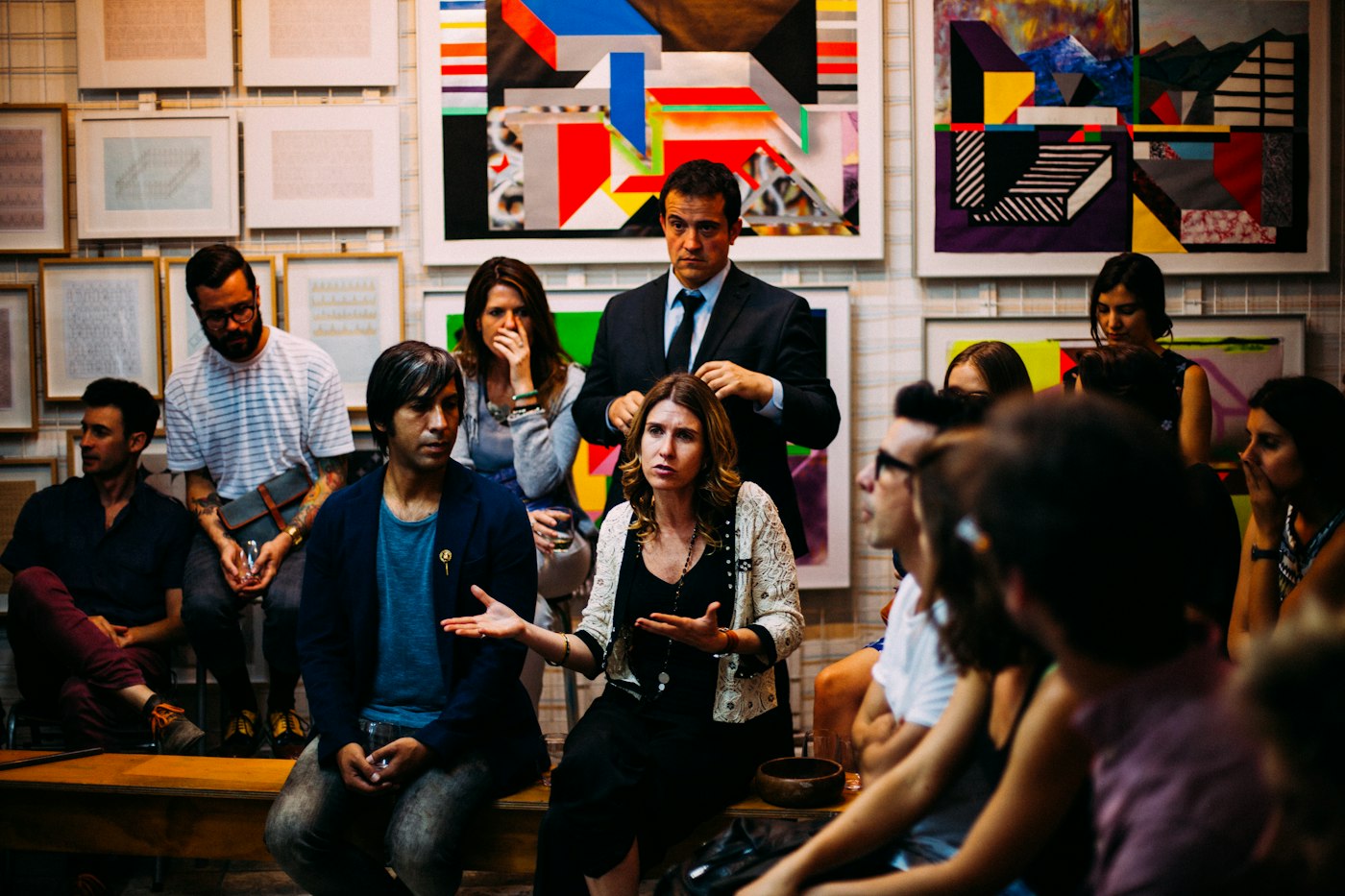 A mixed group in an informal circle, one person speaking while the others listen